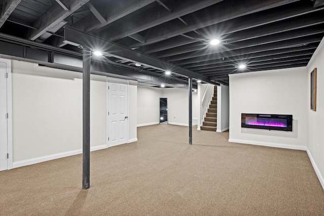 8214 S Paxton Ave, Chicago, IL 60617 - finished below grade area featuring carpet floors, baseboards, stairway, and a glass covered fireplace