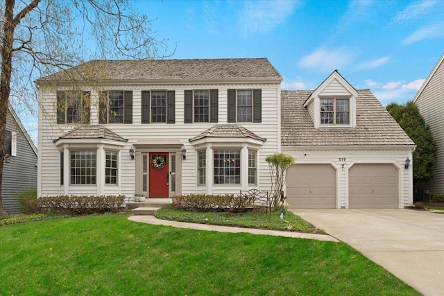 519 Long Hill Rd, Gurnee, IL 60031 - colonial house featuring an attached garage, concrete driveway, and a front yard