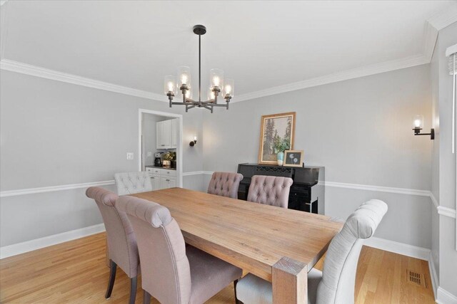519 Long Hill Rd, Gurnee, IL 60031 - dining room with a chandelier, light wood finished floors, ornamental molding, and baseboards