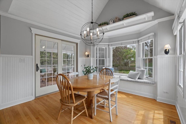519 Long Hill Rd, Gurnee, IL 60031 - dining room featuring light wood-type flooring, a chandelier, wainscoting, plenty of natural light, and a decorative wall