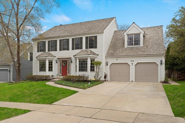 519 Long Hill Rd, Gurnee, IL 60031 - colonial home featuring concrete driveway, a front yard, and an attached garage