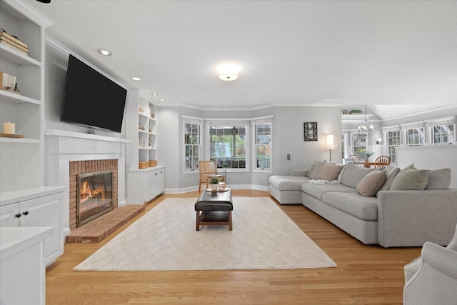 519 Long Hill Rd, Gurnee, IL 60031 - living area featuring crown molding, a brick fireplace, light wood-style floors, a chandelier, and recessed lighting