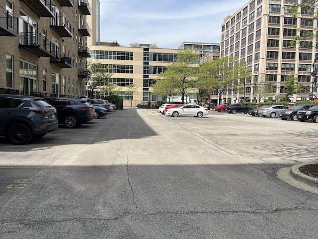 view of apartment building / complex with uncovered parking