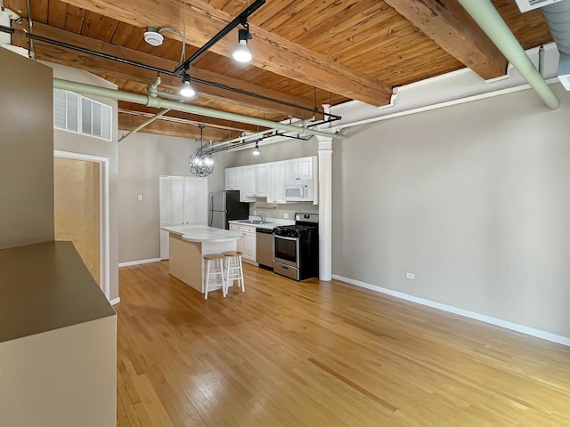 kitchen with track lighting, stainless steel appliances, wooden ceiling, baseboards, and light wood-style floors
