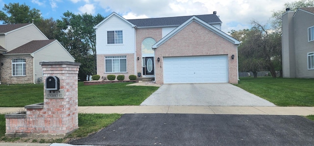 traditional-style home featuring brick siding, a front yard, driveway, and a garage