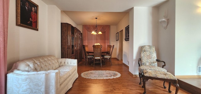 dining space featuring a chandelier and wood finished floors