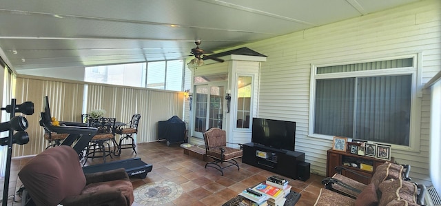 sunroom featuring vaulted ceiling and a ceiling fan