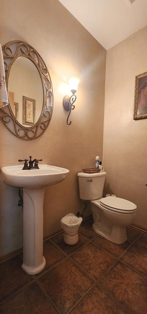 bathroom with toilet and tile patterned flooring