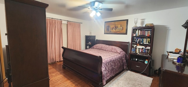 bedroom with wood finished floors and a ceiling fan