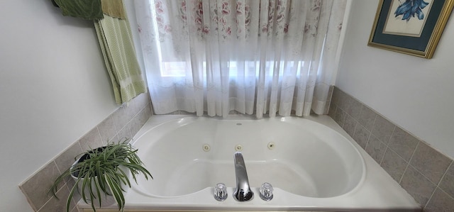full bathroom featuring a tub with jets