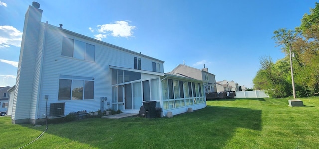 rear view of property with a sunroom and cooling unit