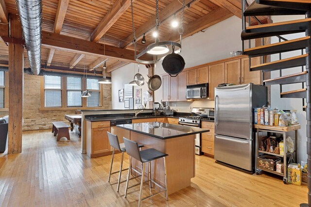 2435 N Sheffield Ave Unit 10, Chicago, IL 60614 - kitchen featuring stainless steel appliances, a peninsula, wood ceiling, light wood-style flooring, and dark countertops