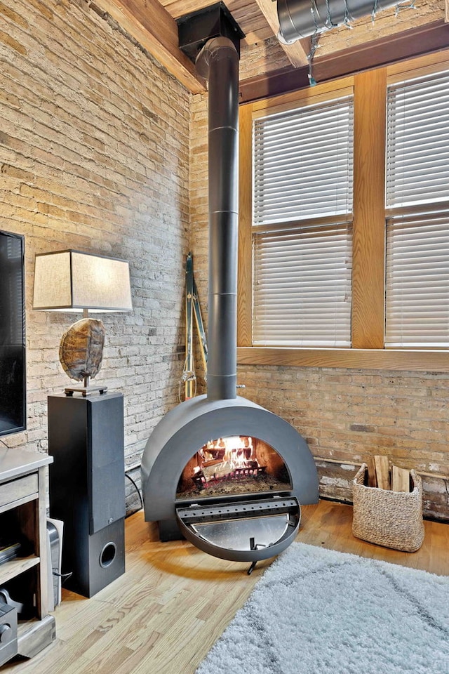2435 N Sheffield Ave Unit 10, Chicago, IL 60614 - detailed view of a wood stove, wood finished floors, and brick wall