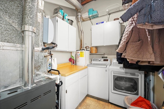 2435 N Sheffield Ave Unit 10, Chicago, IL 60614 - laundry area with washer and dryer, gas water heater, and cabinet space