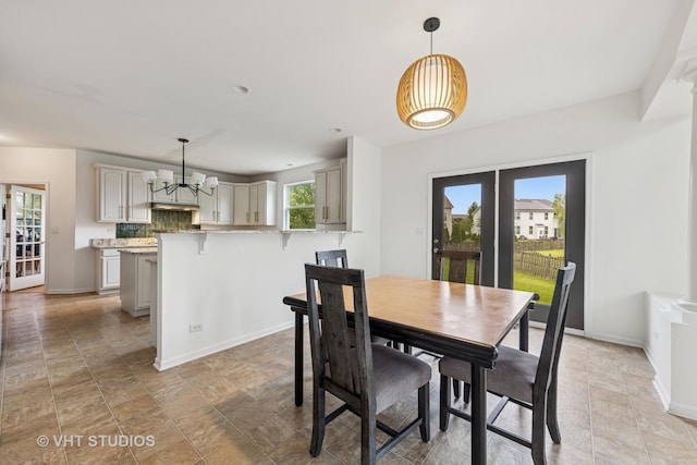 635 Mansfield Way, Oswego, IL 60543 - dining room with a chandelier, french doors, baseboards, and stone finish floors