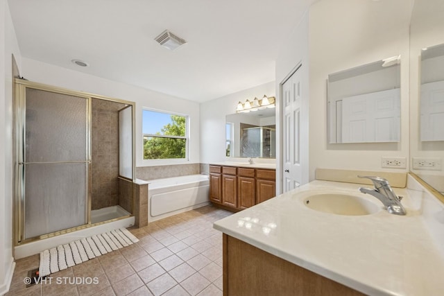 635 Mansfield Way, Oswego, IL 60543 - bathroom with two vanities, a bath, tile patterned floors, and a stall shower