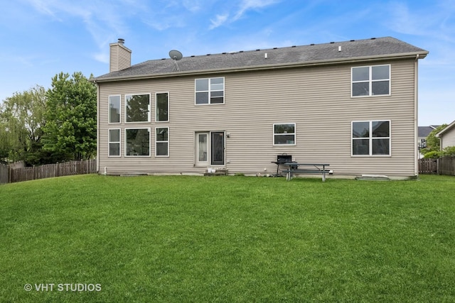 635 Mansfield Way, Oswego, IL 60543 - rear view of house featuring a chimney and entry steps