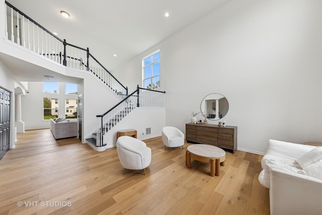 635 Mansfield Way, Oswego, IL 60543 - sitting room featuring stairway, a high ceiling, light wood-type flooring, recessed lighting, and baseboards