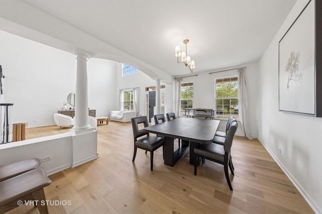 635 Mansfield Way, Oswego, IL 60543 - dining room featuring ornate columns, light wood-type flooring, baseboards, and a chandelier
