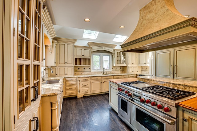 1565 Winberie Ct, Naperville, IL 60564 - kitchen with cream cabinets, a skylight, range with two ovens, a sink, and recessed lighting