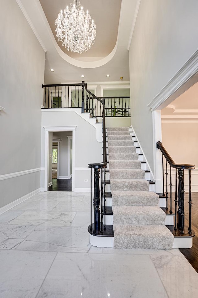 1565 Winberie Ct, Naperville, IL 60564 - stairway with crown molding, a chandelier, baseboards, a towering ceiling, and marble tiled floors