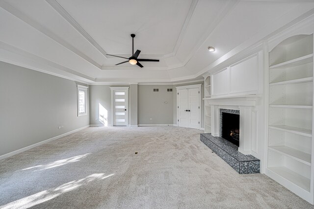1565 Winberie Ct, Naperville, IL 60564 - unfurnished living room featuring a tray ceiling, carpet, ceiling fan, a fireplace, and baseboards