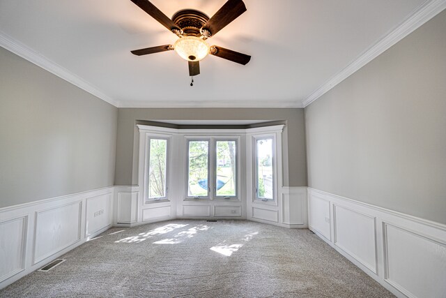 1565 Winberie Ct, Naperville, IL 60564 - carpeted spare room featuring a decorative wall, ornamental molding, a wainscoted wall, and ceiling fan