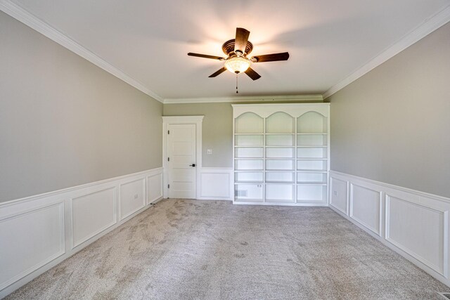 1565 Winberie Ct, Naperville, IL 60564 - carpeted spare room featuring ceiling fan, a decorative wall, crown molding, and a wainscoted wall