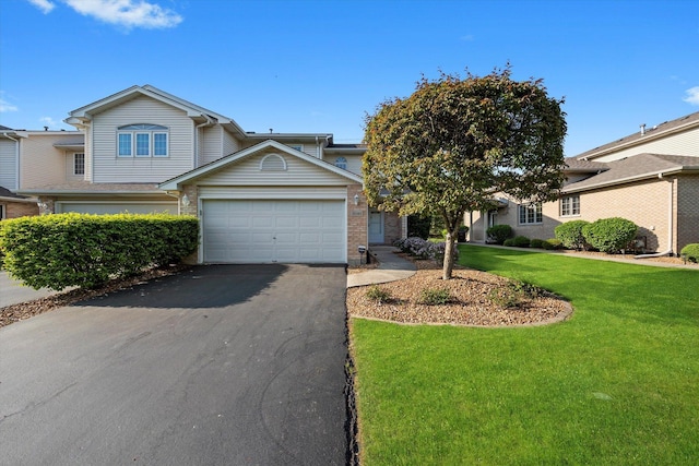 11046 Quail Dr, Mokena, IL 60448 - view of front of house with asphalt driveway, a front lawn, brick siding, and a garage
