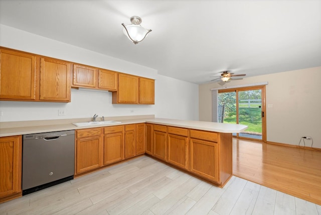 11046 Quail Dr, Mokena, IL 60448 - kitchen with stainless steel dishwasher, a sink, light countertops, light wood-style floors, and a peninsula