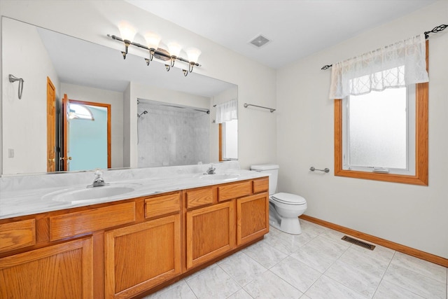 11046 Quail Dr, Mokena, IL 60448 - full bathroom with toilet, a shower, baseboards, and double vanity