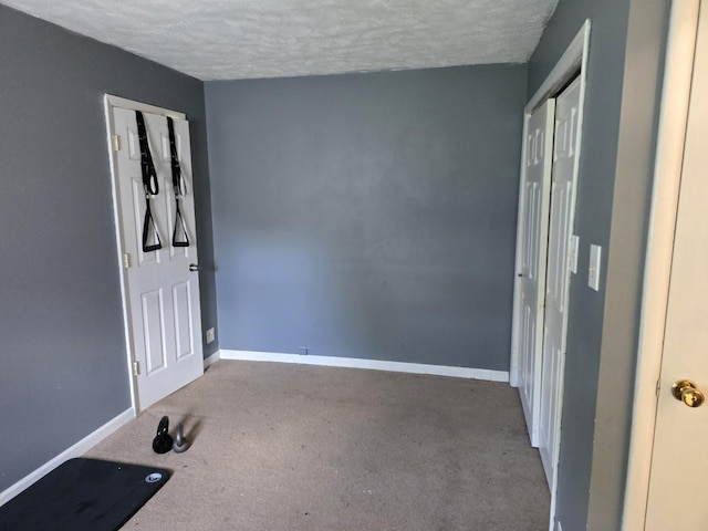 320 N Pearl St, Forrest, IL 61741 - unfurnished bedroom featuring carpet floors, a textured ceiling, baseboards, and a closet