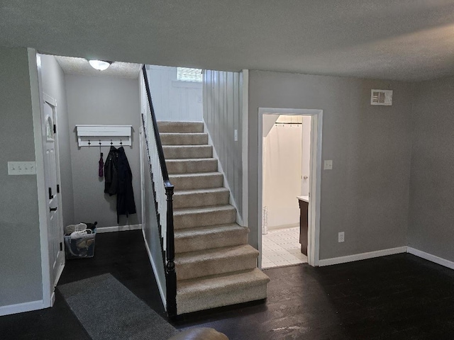 320 N Pearl St, Forrest, IL 61741 - stairway with baseboards, wood finished floors, and a textured ceiling