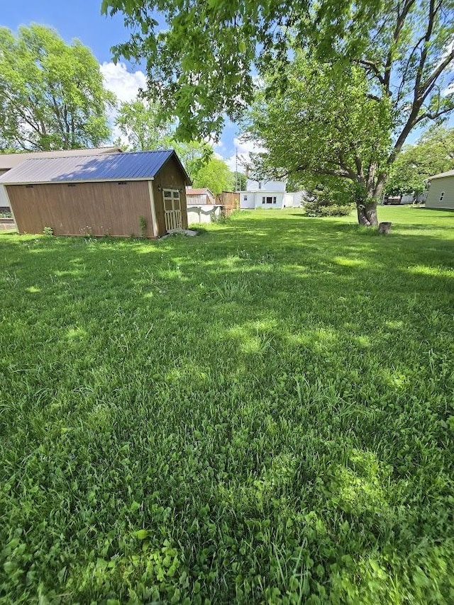 320 N Pearl St, Forrest, IL 61741 - view of green lawn with an outbuilding and a storage shed