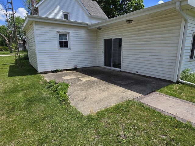 320 N Pearl St, Forrest, IL 61741 - rear view of house featuring a yard and a patio area