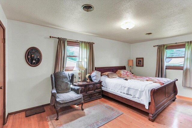 7 Birch Ln, Villa Grove, IL 61956 - bedroom featuring light wood-style floors, a textured ceiling, and baseboards