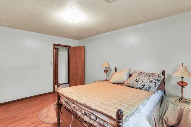 7 Birch Ln, Villa Grove, IL 61956 - bedroom featuring wood finished floors, baseboards, and a textured ceiling