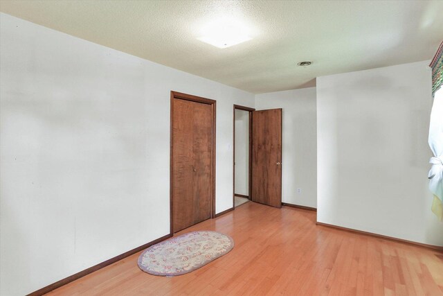 7 Birch Ln, Villa Grove, IL 61956 - unfurnished bedroom with light wood finished floors, baseboards, and a closet