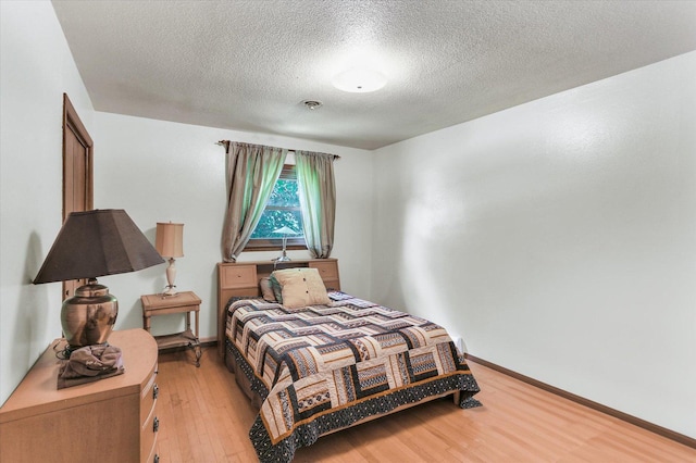 7 Birch Ln, Villa Grove, IL 61956 - bedroom featuring light wood-type flooring, a textured ceiling, and baseboards