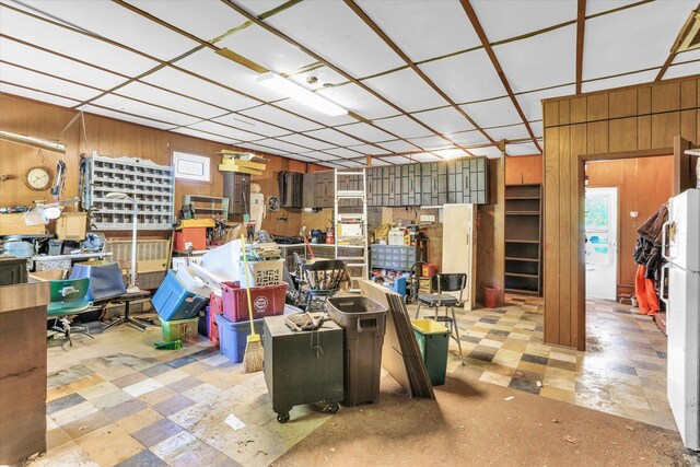 7 Birch Ln, Villa Grove, IL 61956 - below grade area featuring tile patterned floors, wooden walls, and freestanding refrigerator
