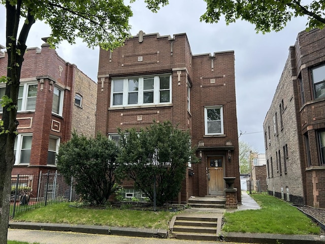 view of front of property featuring brick siding and fence