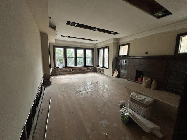 unfurnished living room featuring a fireplace and wood finished floors