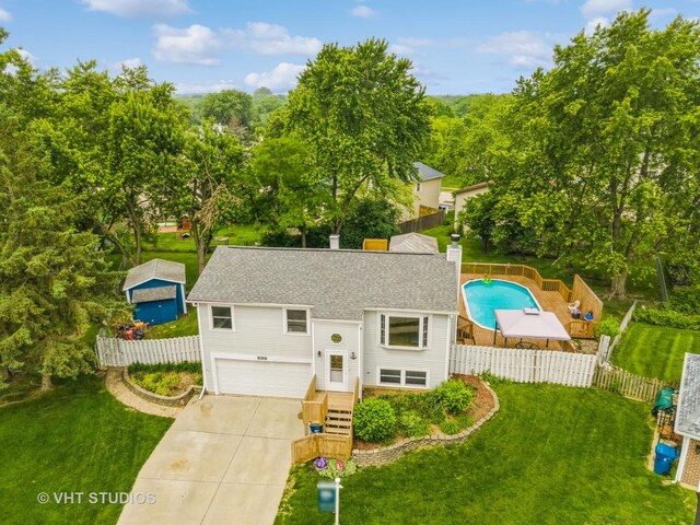 898 Shorewood Dr, Bartlett, IL 60103 - view of front facade featuring a garage, a shingled roof, driveway, and a chimney