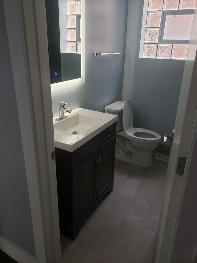 half bathroom with toilet and vanity