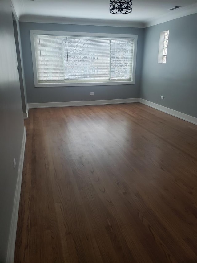 empty room with dark wood-type flooring and baseboards