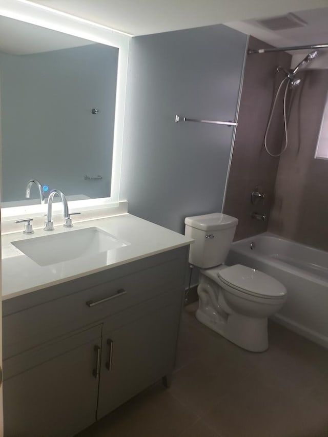 bathroom with tile patterned flooring, toilet, vanity, and shower / bath combination