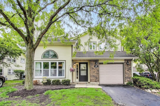 405 W Ivy Ln Unit 4A, Arlington Heights, IL 60004 - traditional-style house featuring a garage, brick siding, and driveway