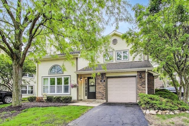 405 W Ivy Ln Unit 4A, Arlington Heights, IL 60004 - traditional-style house featuring a garage, driveway, and brick siding