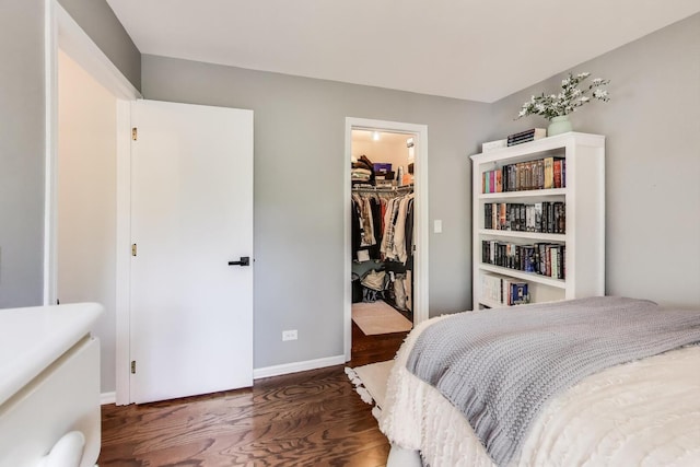 405 W Ivy Ln Unit 4A, Arlington Heights, IL 60004 - bedroom featuring wood finished floors, baseboards, a walk in closet, and a closet