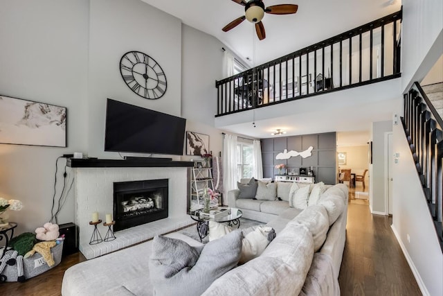 405 W Ivy Ln Unit 4A, Arlington Heights, IL 60004 - living room featuring a fireplace, a ceiling fan, wood finished floors, stairs, and high vaulted ceiling